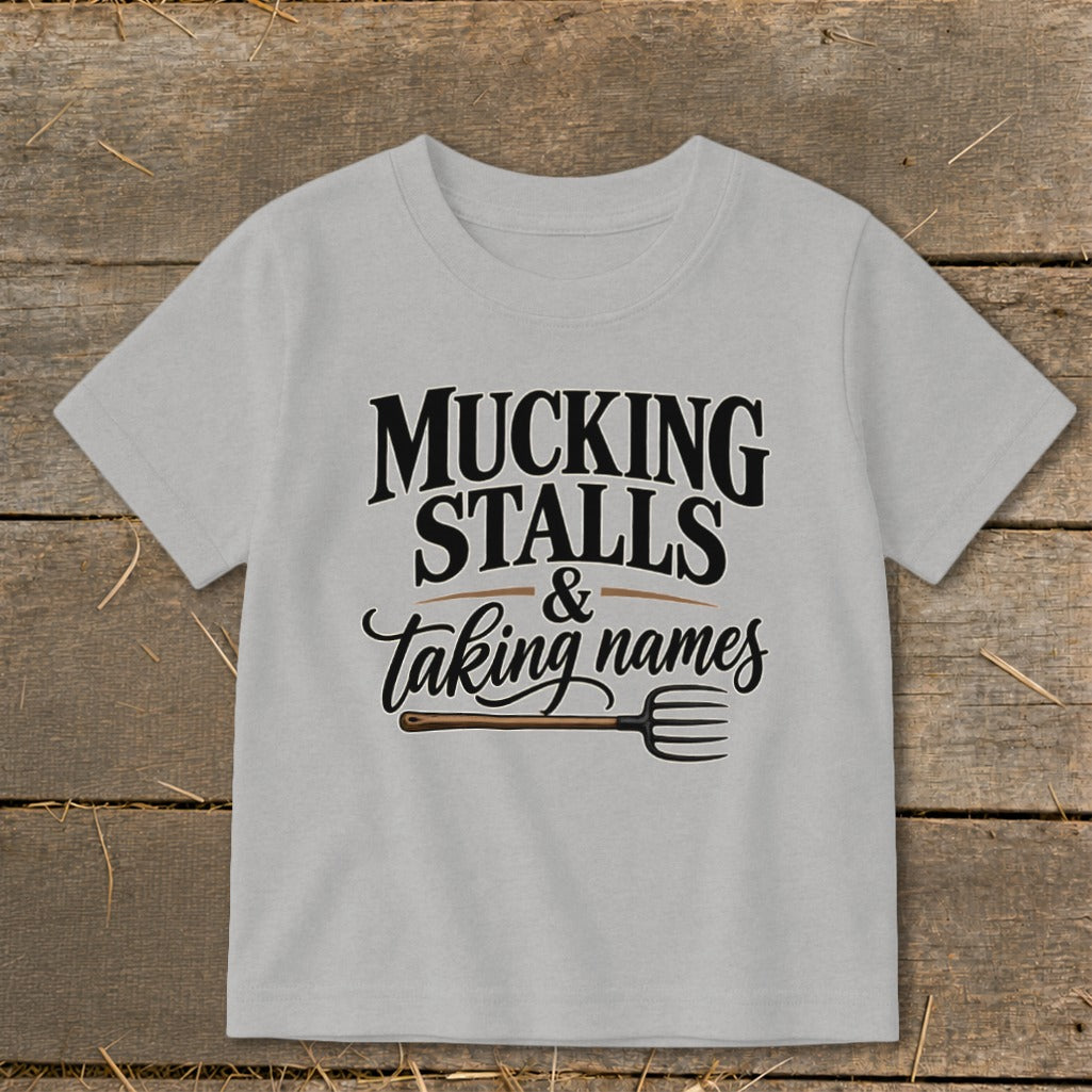 Light grey t-shirt with "MUCKING STALLS & taking names" and a pitchfork.