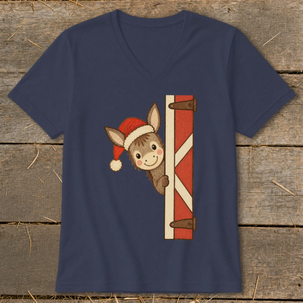 Donkey wearing Santa hat peeking from barn door on navy t-shirt.