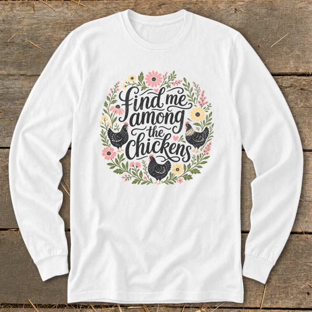 White long-sleeve shirt with floral wreath and "Find me among the chickens" text.