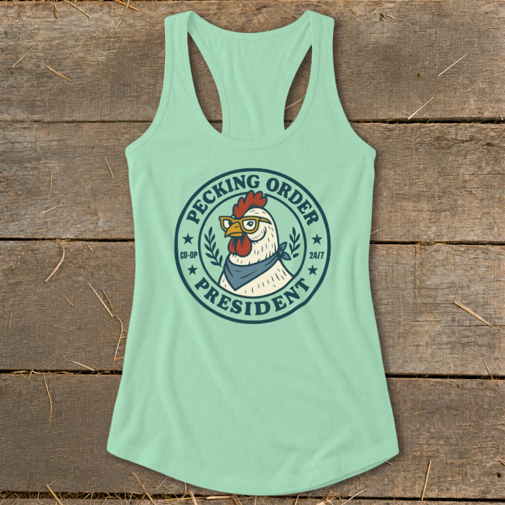 Mint green tank top with a circular graphic of a chicken wearing glasses and a bandana, reading "Pecking Order President."