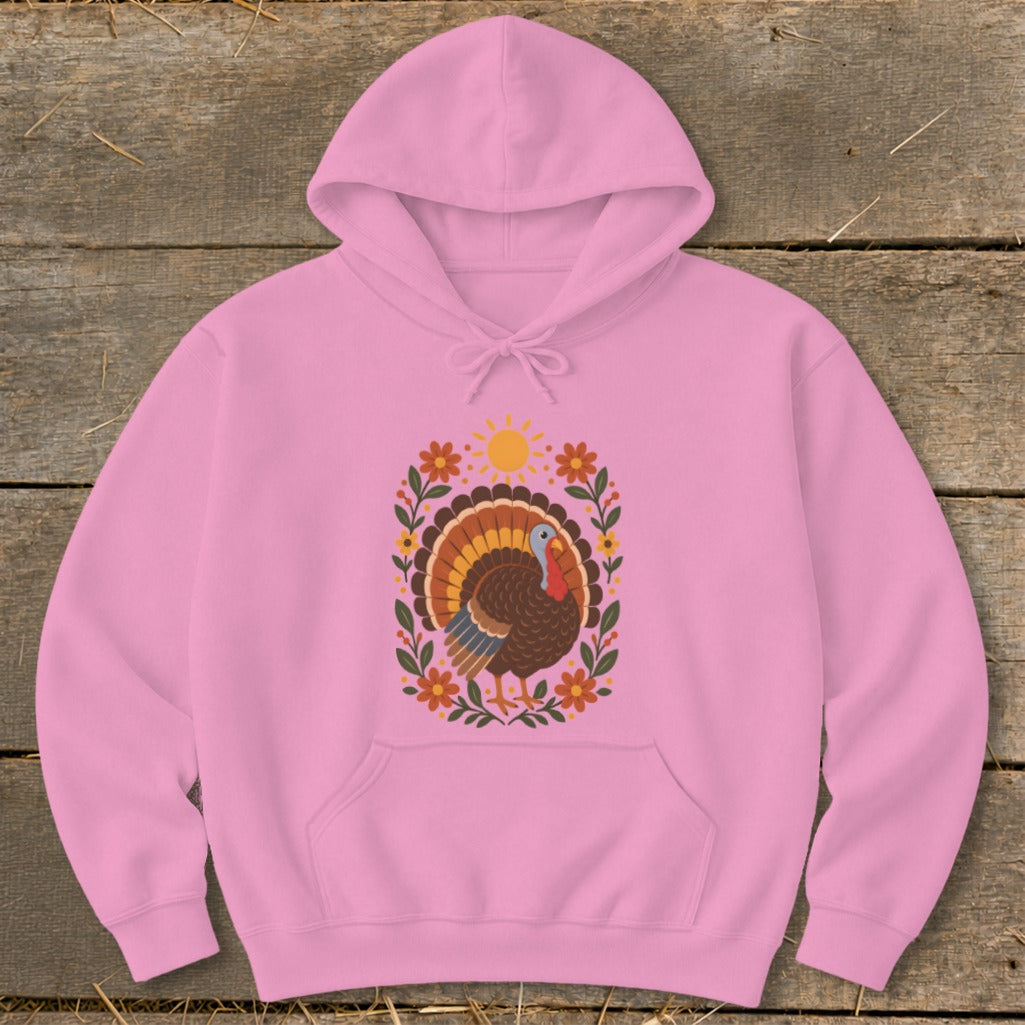 Pink hoodie with a colorful turkey and floral design, including a sun.