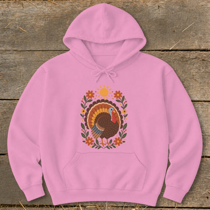 Pink hoodie with a colorful turkey and floral design, including a sun.