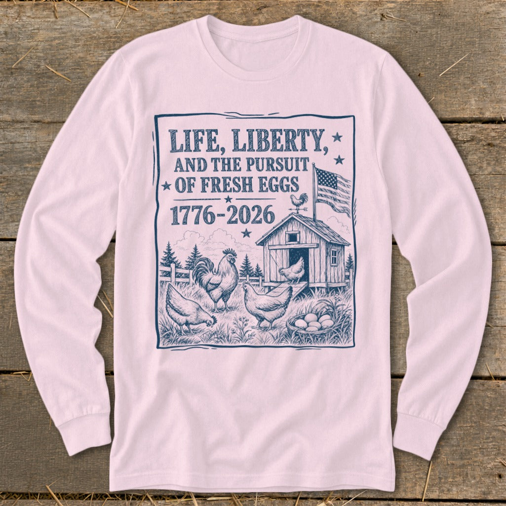 T-shirt graphic with chickens, coop, and text "Life, Liberty, and the Pursuit of Fresh Eggs 1776-2026".