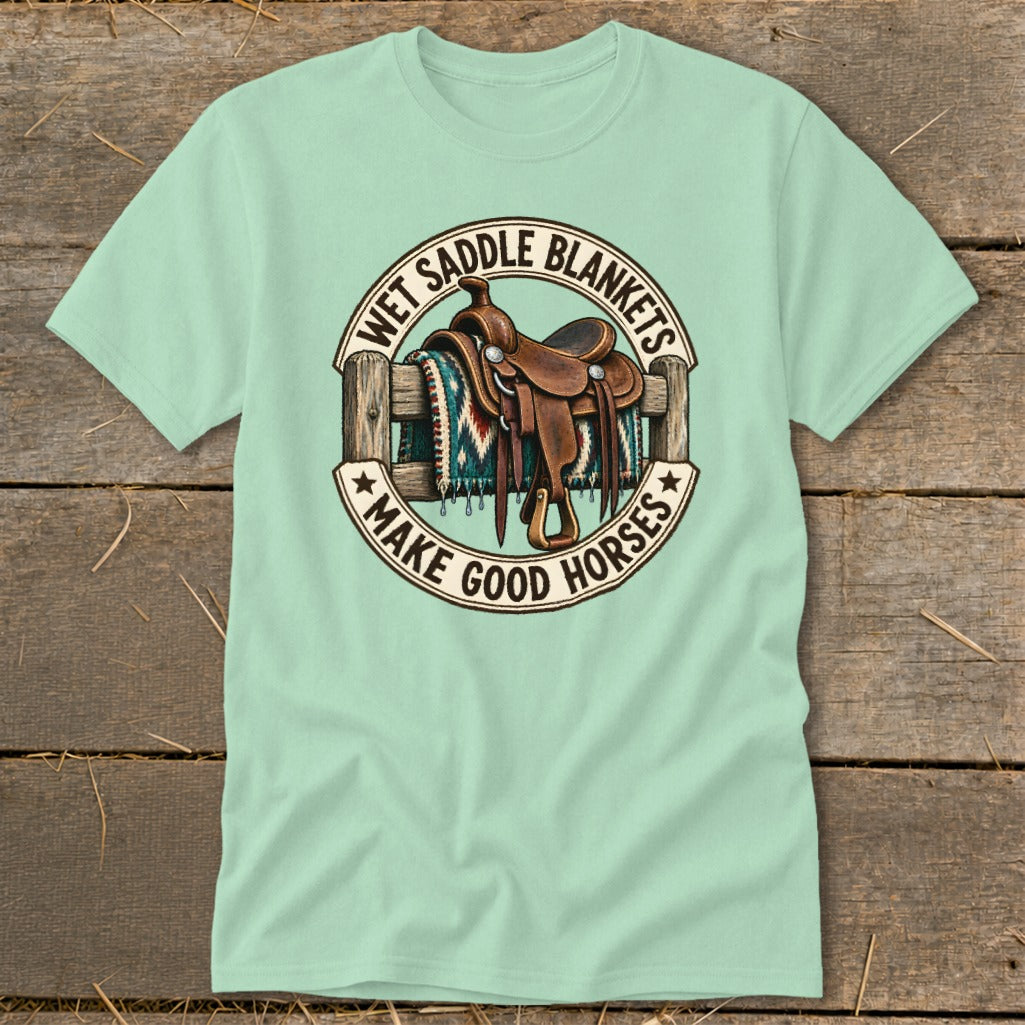 Mint t-shirt with graphic of western saddle on fence, reads "Wet Saddle Blankets Make Good Horses."