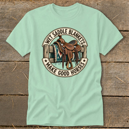 Mint t-shirt with graphic of western saddle on fence, reads "Wet Saddle Blankets Make Good Horses."