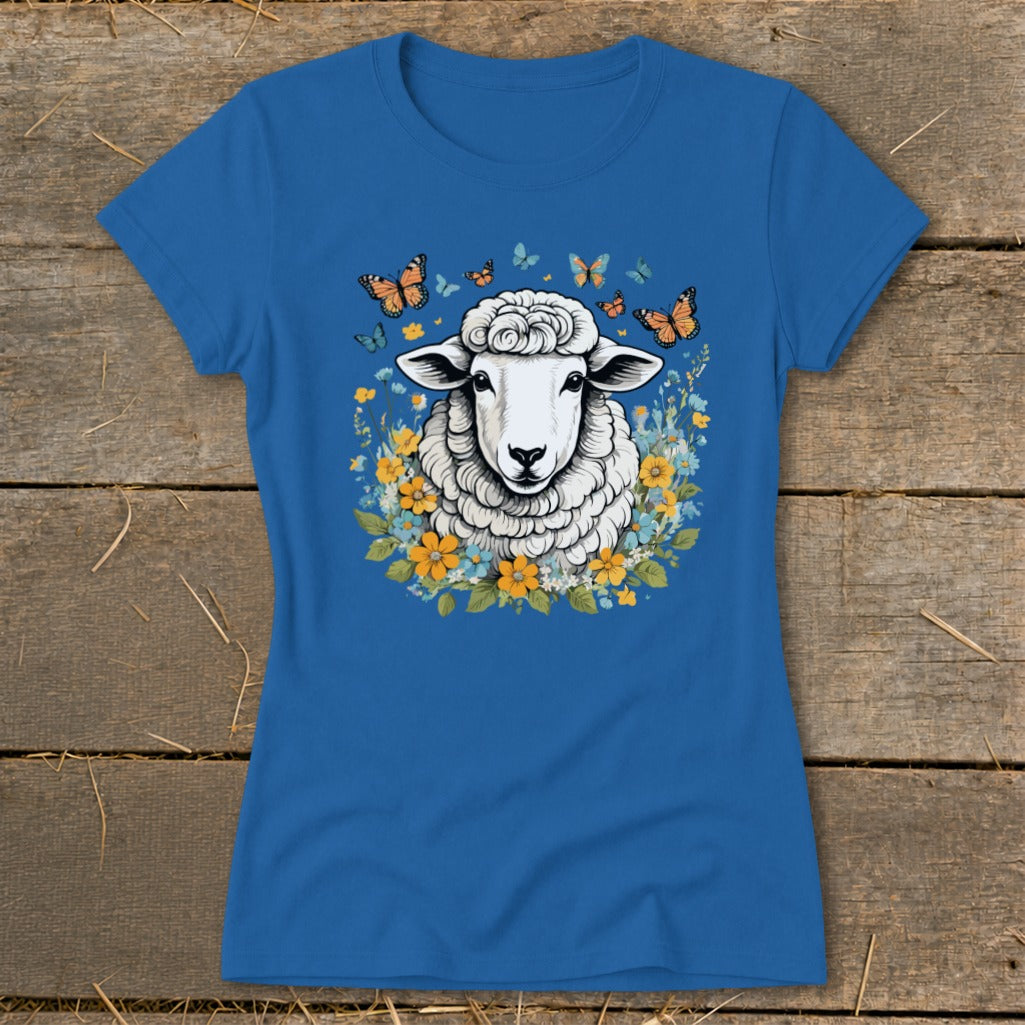 Blue t-shirt with a sheep graphic surrounded by flowers and butterflies.