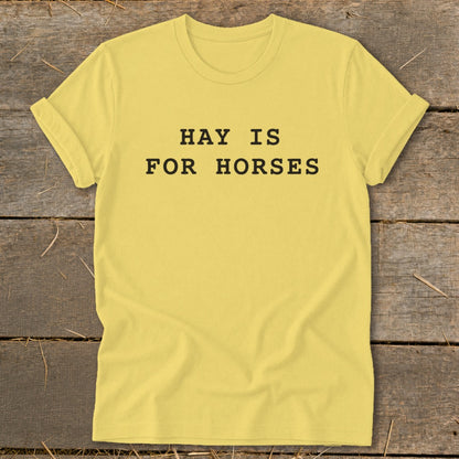 Yellow t-shirt with black text that reads "HAY IS FOR HORSES".