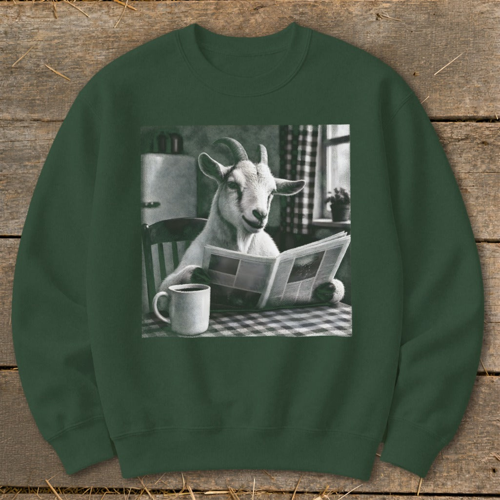 Dark green crewneck sweatshirt featuring a graphic of a goat sitting at a checkered table, reading a newspaper beside a coffee mug.