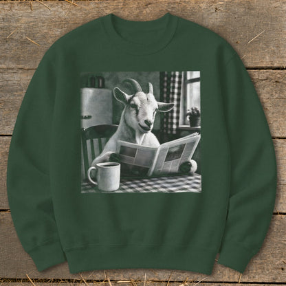 Dark green crewneck sweatshirt featuring a graphic of a goat sitting at a checkered table, reading a newspaper beside a coffee mug.