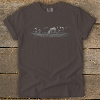 Dark grey t-shirt with a graphic of several cows grazing in a field.