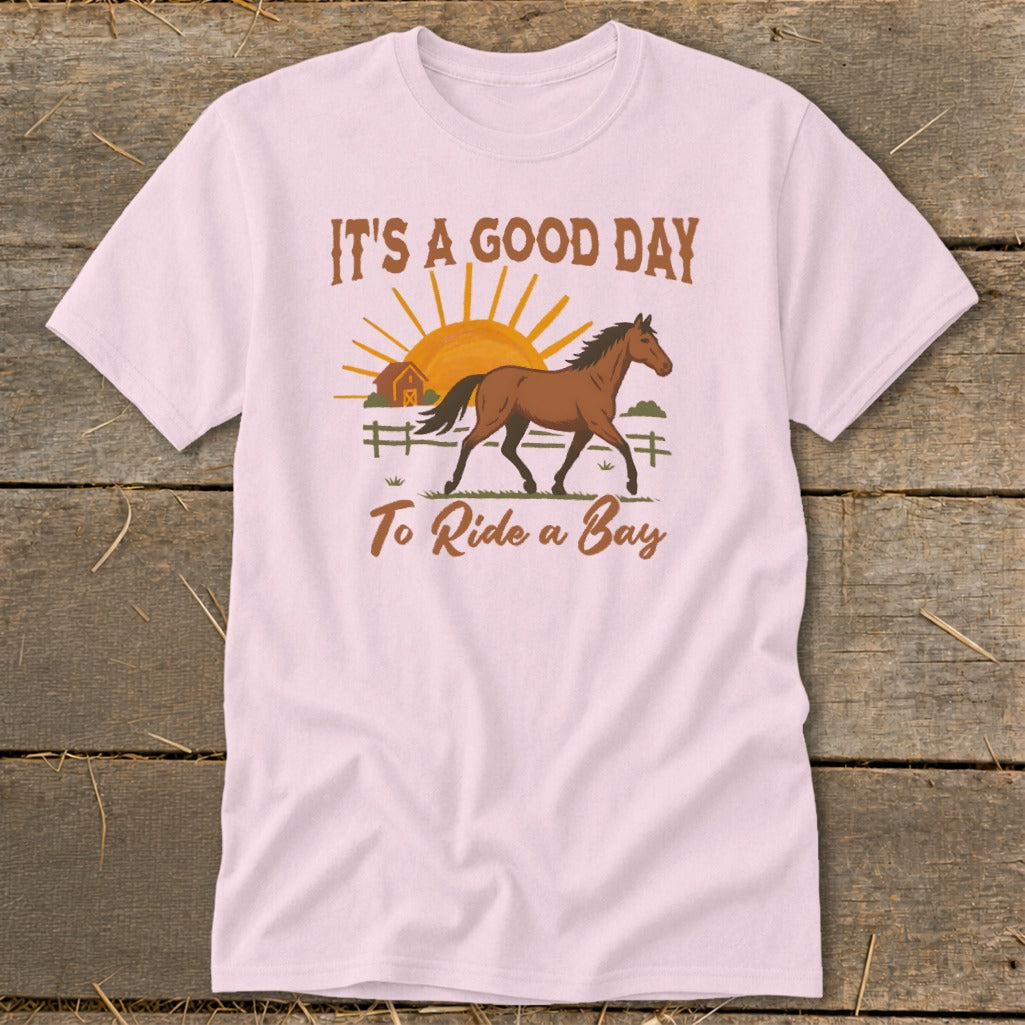 Pink t-shirt with "It's a good day to ride a bay" text and horse graphic.