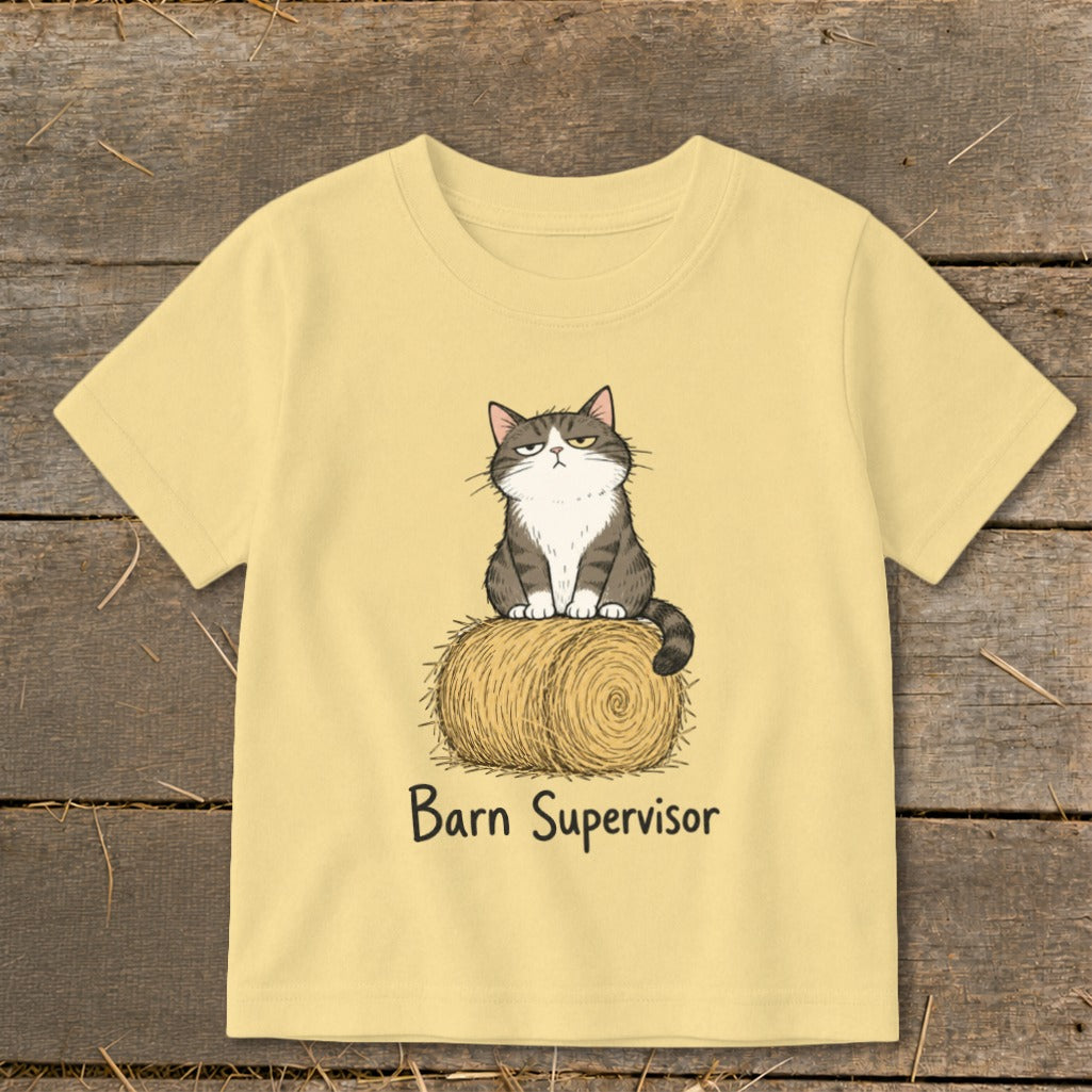 Light yellow t-shirt with a cartoon cat sitting on a hay bale, text "Barn Supervisor".