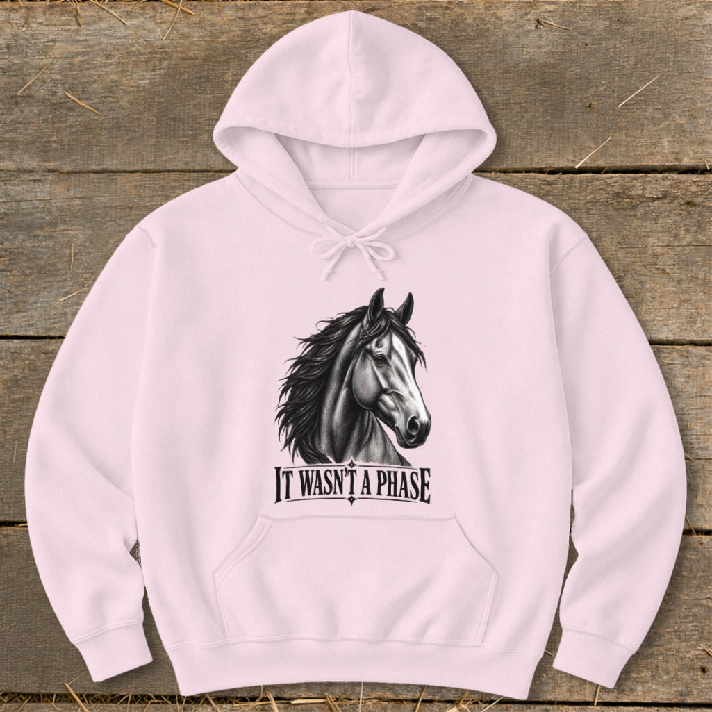 Light pink hoodie with black horse graphic and "IT WASN'T A PHASE" text.