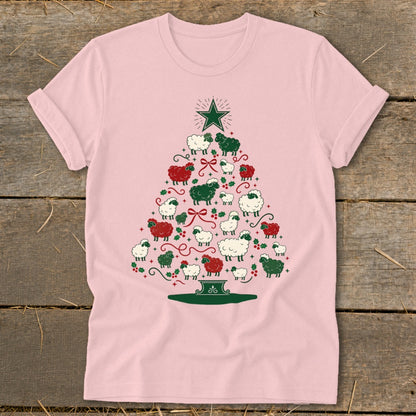 Pink t-shirt with a Christmas tree made of sheep, holly, and a star.