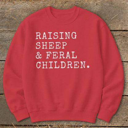 Red sweatshirt with white text reading "RAISING SHEEP & FERAL CHILDREN."