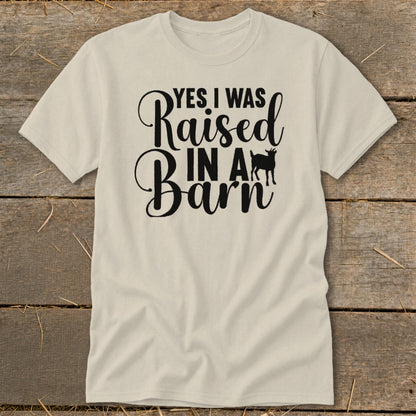 Cream t-shirt with black text "Yes I Was Raised In A Barn" and a goat silhouette.