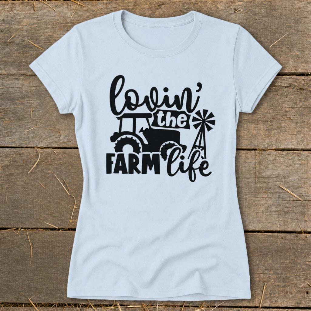 Light blue t-shirt with black graphic: "lovin' the FARM life" with tractor and windmill.