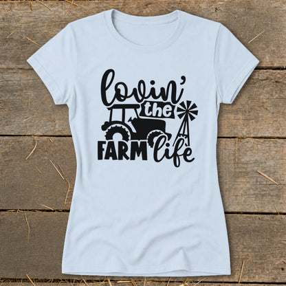 Light blue t-shirt with black graphic: "lovin' the FARM life" with tractor and windmill.