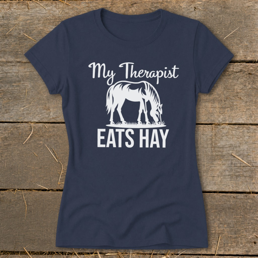 Navy t-shirt with white text and a horse graphic reading "My Therapist Eats Hay".