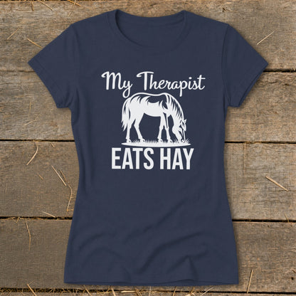 Navy t-shirt with white text and a horse graphic reading "My Therapist Eats Hay".