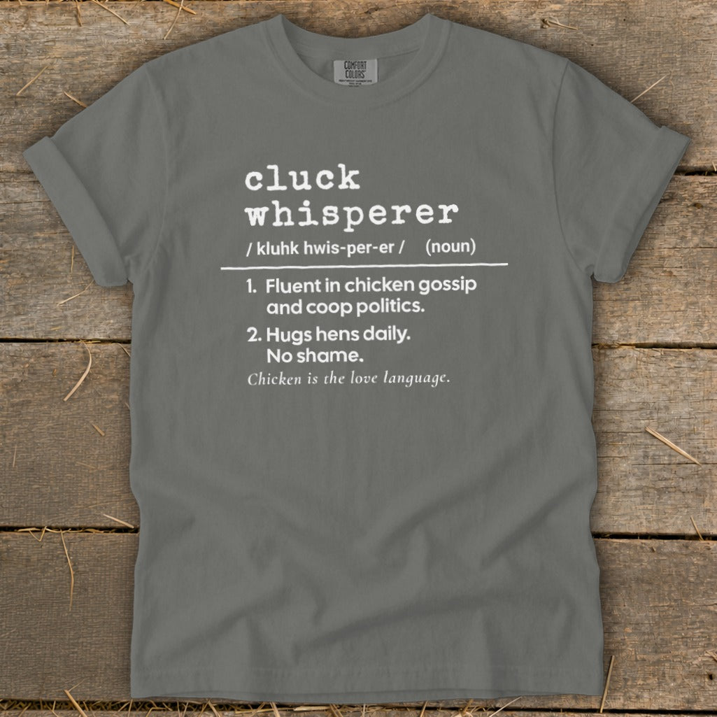 Gray t-shirt with "Cluck Whisperer" definition: fluent in chicken gossip, hugs hens daily, chicken is love language.