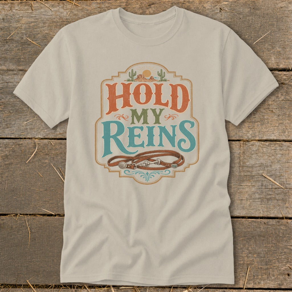 Light-colored t-shirt with "HOLD MY REINS" text and leather reins graphic.