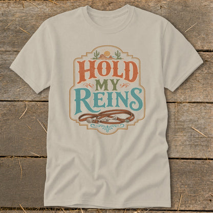 Light-colored t-shirt with "HOLD MY REINS" text and leather reins graphic.