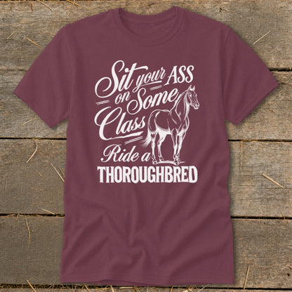 A maroon crewneck t-shirt featuring white text and an illustration of a horse.