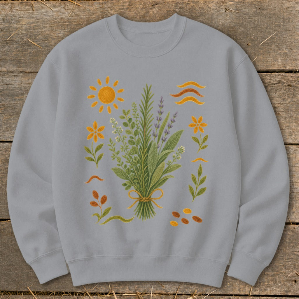 Grey sweatshirt with a central bouquet of herbs and surrounding sun, flowers, and seeds.