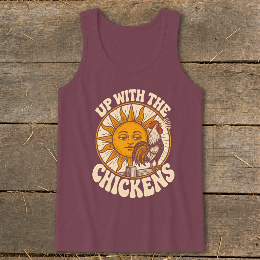 A maroon tank top with a vintage graphic of a rooster crowing before a sun, featuring the text Up with the Chickens.