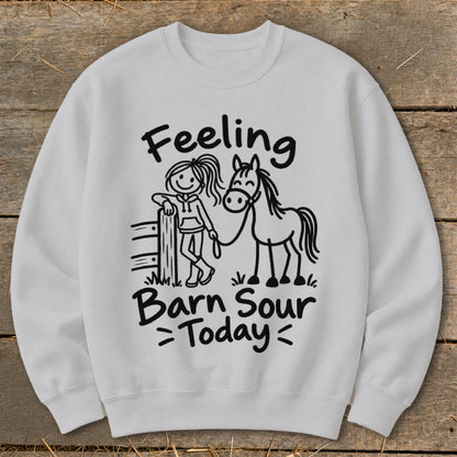 White sweatshirt with black graphic of a girl and horse, reading "Feeling Barn Sour Today".