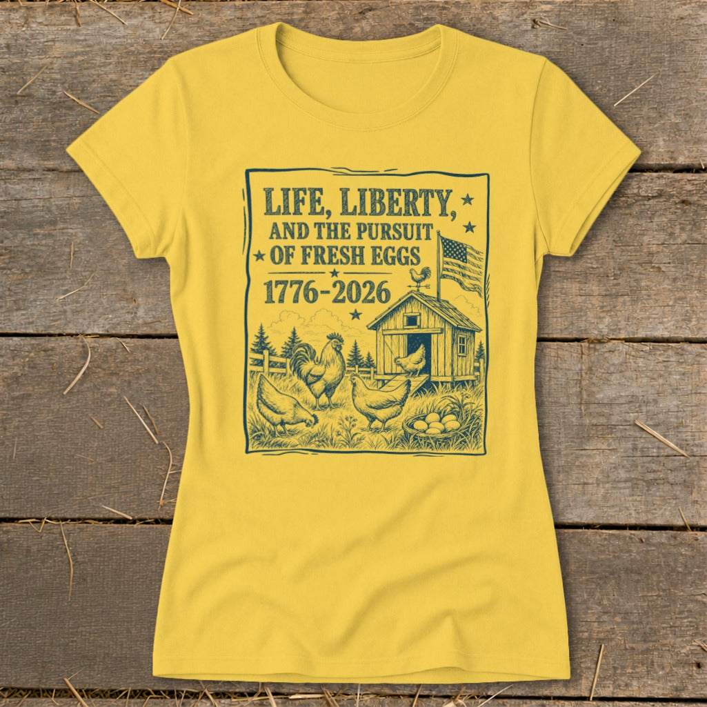 Yellow t-shirt with "Life, Liberty, and the Pursuit of Fresh Eggs 1776-2026" graphic.