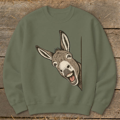 Green sweatshirt with a humorous drawing of a donkey peeking out from the side.