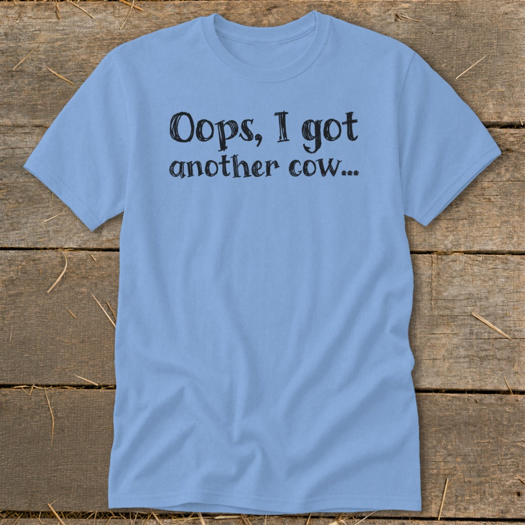 Light blue t-shirt with "Oops, I got another cow..." in black text.
