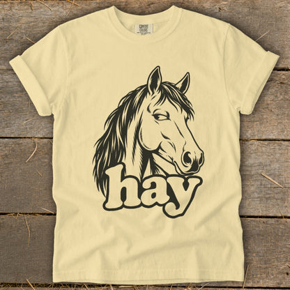 Light yellow t-shirt with black horse head graphic and "hay" text.