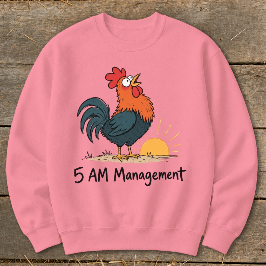 Pink sweatshirt with a cartoon rooster crowing at sunrise and text "5 AM Management."