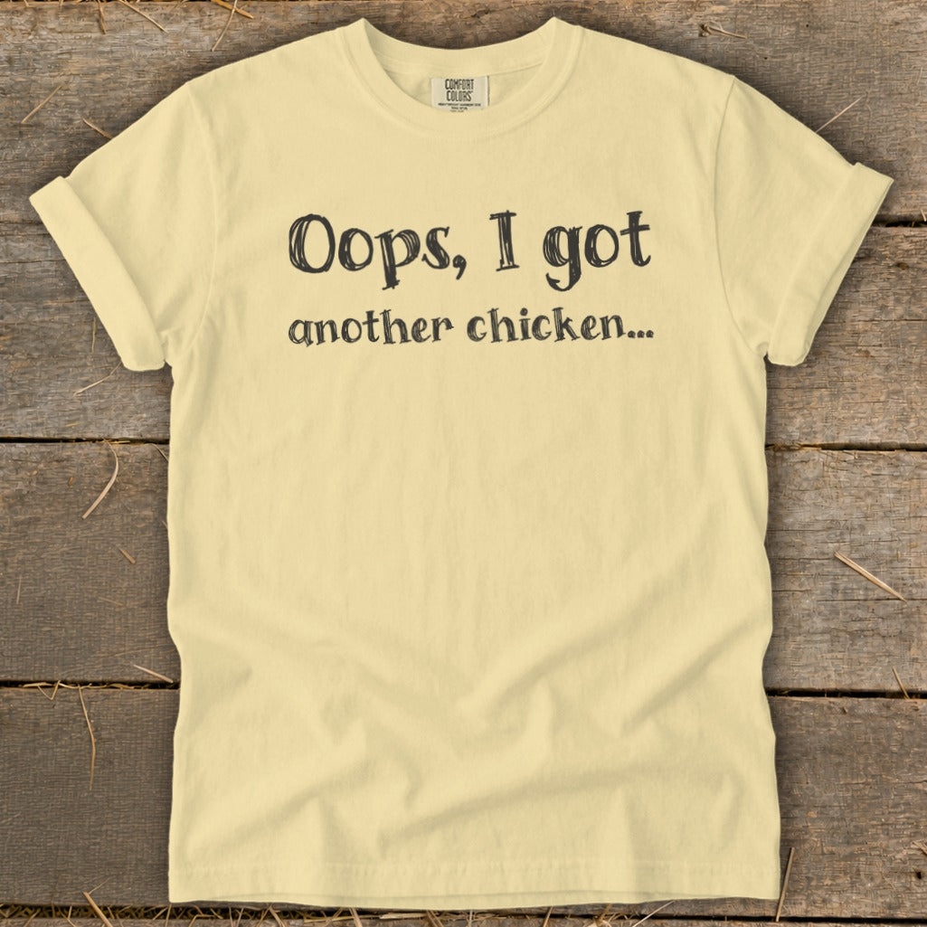 Yellow t-shirt with "Oops, I got another chicken..." text.