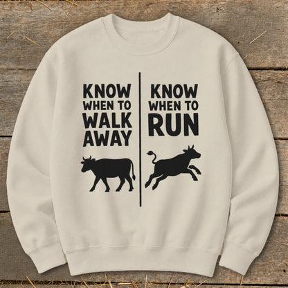 Cream sweatshirt with black text and cow graphics, "Know When to Walk Away" and "Know When to Run".