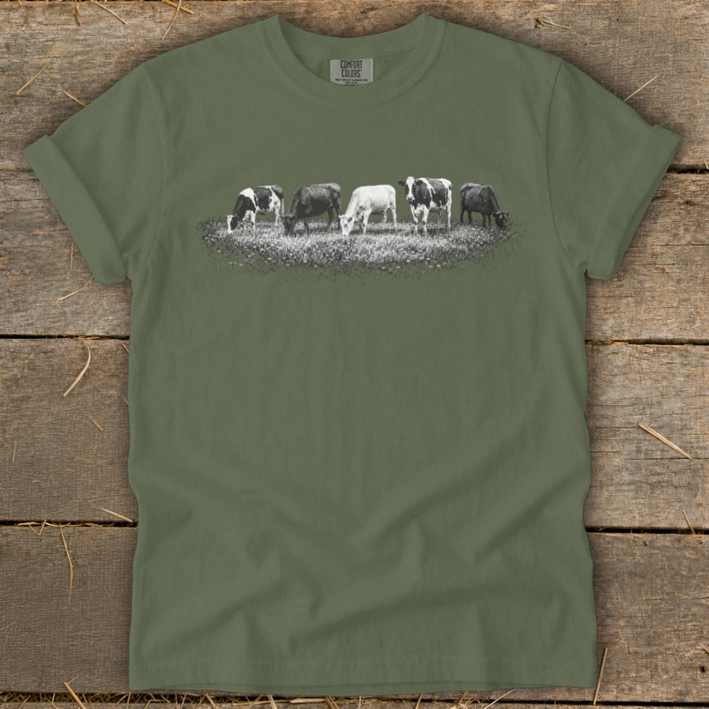 T-shirt with black and white graphic of five cows grazing in a field.