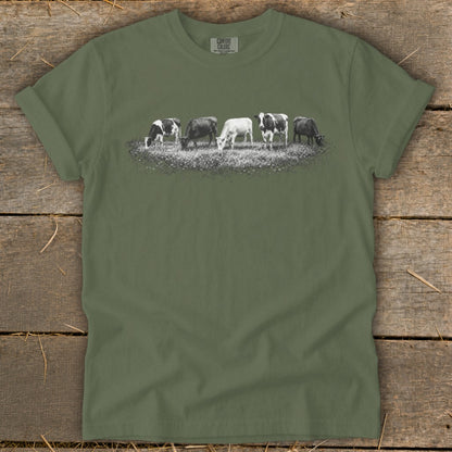 T-shirt with black and white graphic of five cows grazing in a field.