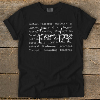 Black t-shirt with white text reading "Farm life" and descriptive words.
