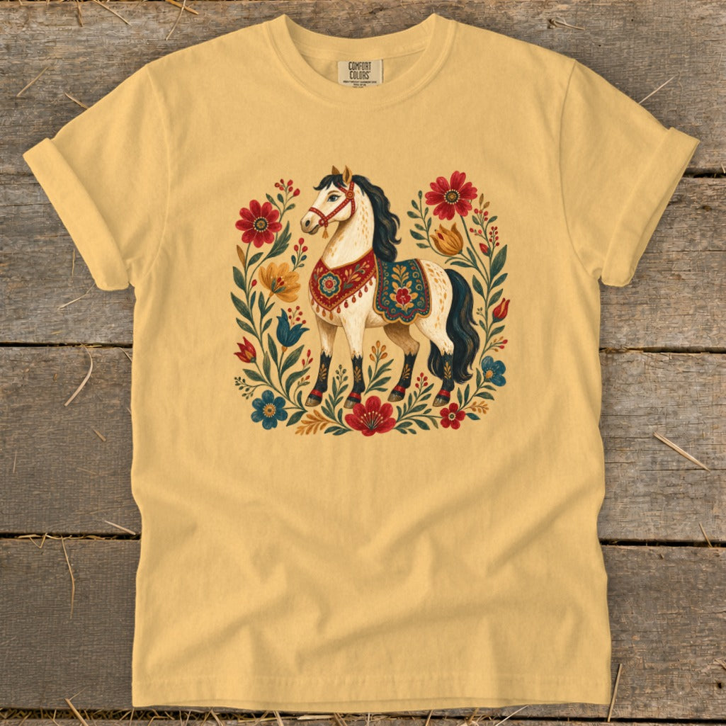 Yellow t-shirt with a white horse illustration surrounded by colorful flowers.