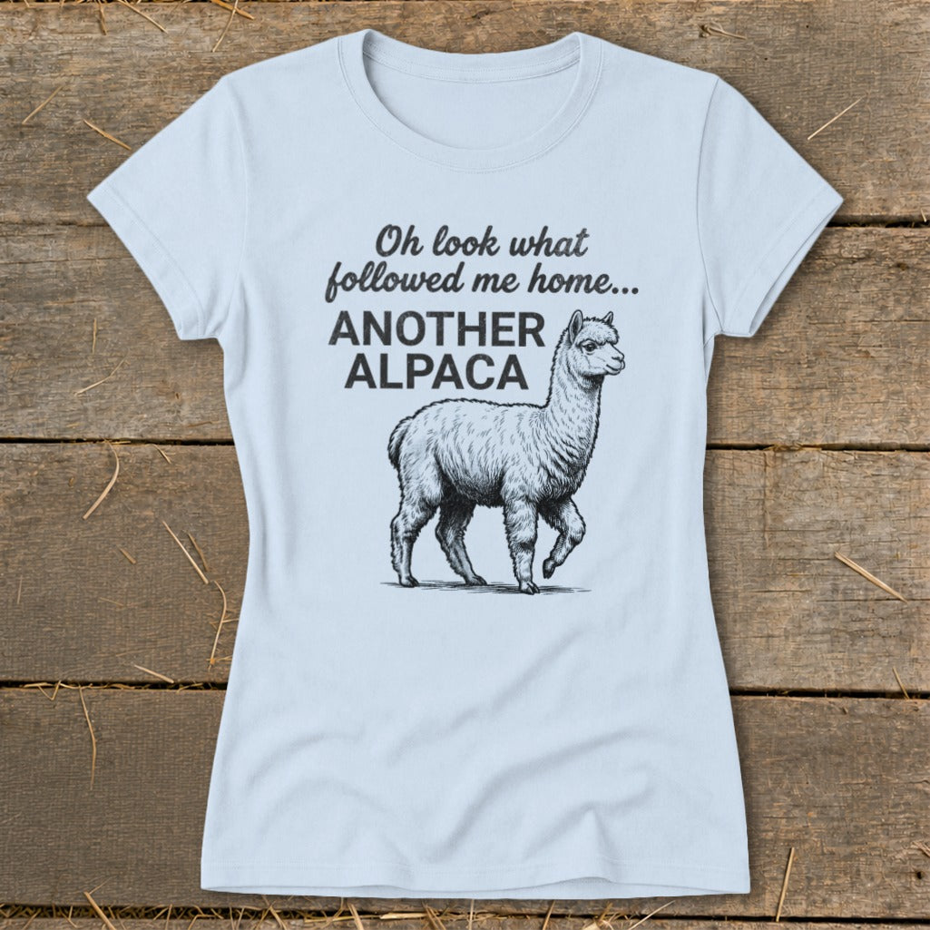 Light blue t-shirt with sketch of an alpaca and text "Oh look what followed me home... ANOTHER ALPACA".