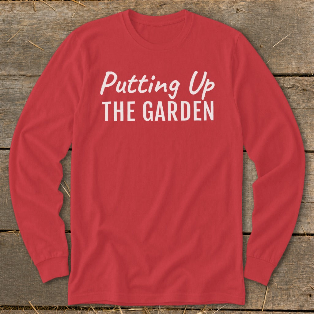 Red long-sleeve t-shirt with "Putting Up THE GARDEN" printed in white.