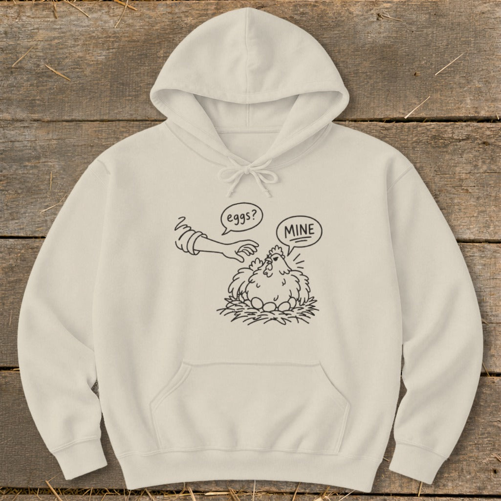Cream hoodie with a line drawing of a hen and eggs, text "eggs?" and "MINE".