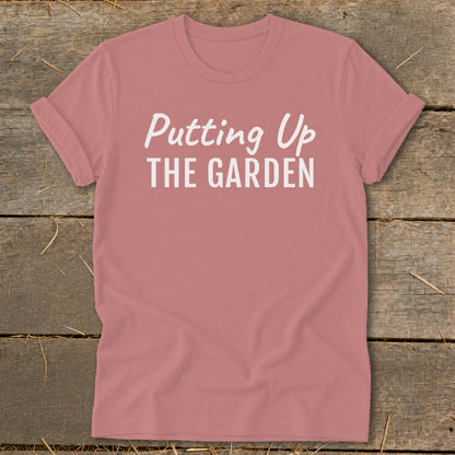Dusty rose t-shirt with white text reading "Putting Up THE GARDEN".