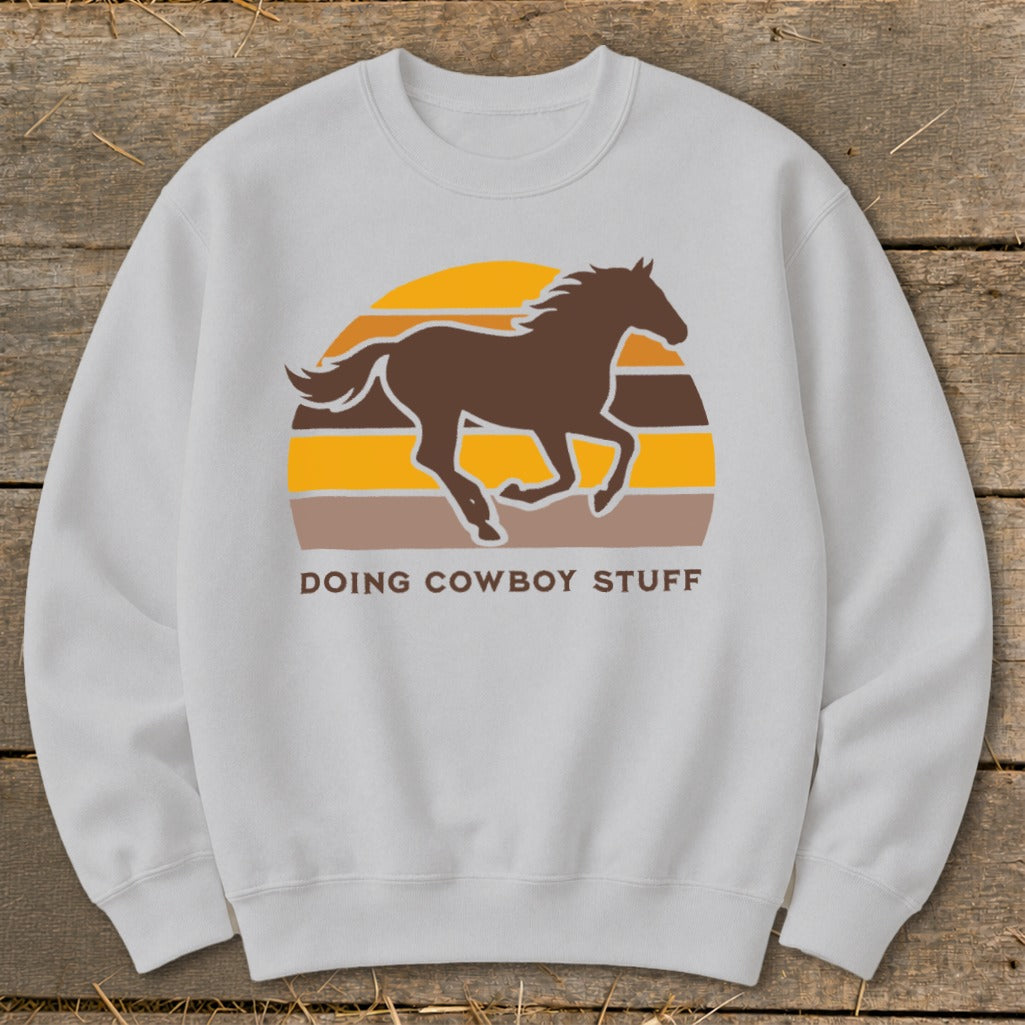 Light gray sweatshirt with brown horse silhouette and "DOING COWBOY STUFF" text.