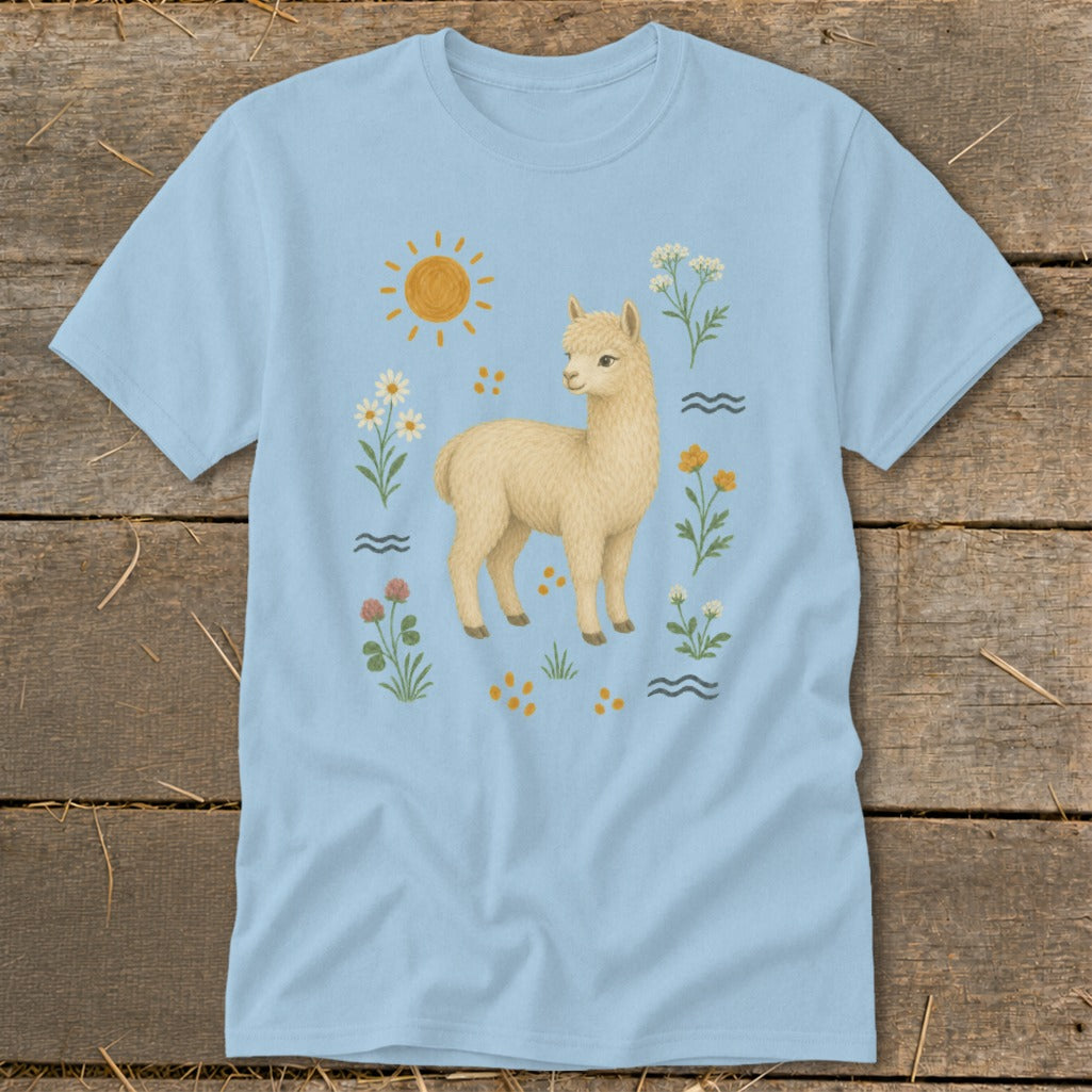Light blue t-shirt with a fluffy yellow alpaca surrounded by flowers and a sun.
