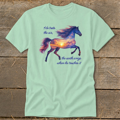 Light green t-shirt featuring a galloping horse graphic filled with a sunset sky and quote text.