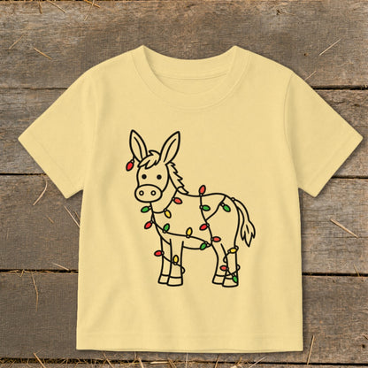 Light yellow t-shirt with a cartoon donkey wrapped in colorful Christmas lights.